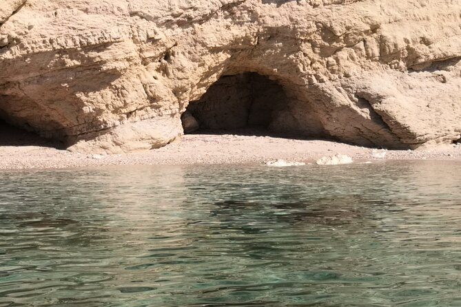 Boat Tour in Cagliari Saddle of the Devil Stops Swimming Snorkeling - Gasole Pools sit beneath Sella del Diavolo