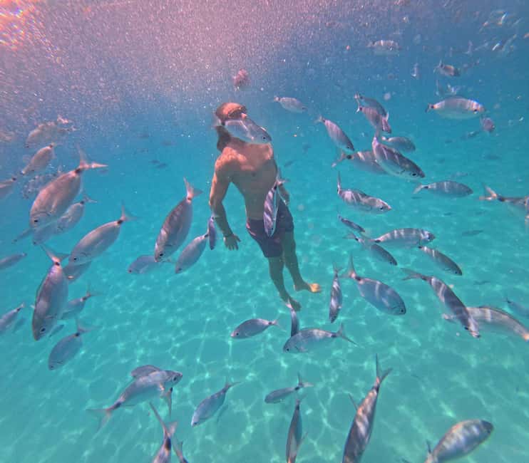 Cagliari: Boat Tour, 4 Stops, Swim, Snorkeling, & 1 Spritz - Cala Fighera: rock, water, and photo time