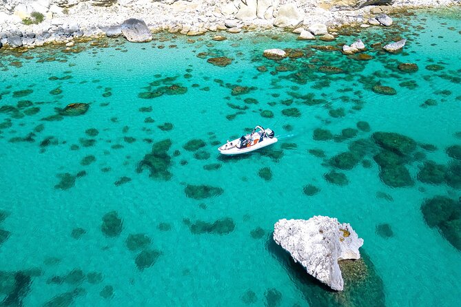 Cagliari Boat Tour with Sardatrips; Swim, Snorkeling, Sip & Snack - Cala Fighera, blue water, and a rough-water warning