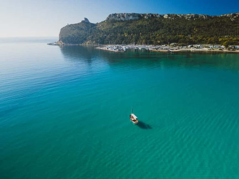 Cagliari: Gozzo Tour with 3 Swim Stops, Snorkel & Local Food - Cala Bernat begins with a quiet coastal look