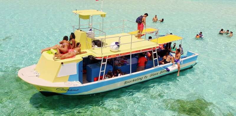 Cozumel: VIP Glass Bottom Boat & Snorkeling 3 Reefs Tour - Boarding the glass bottom boat