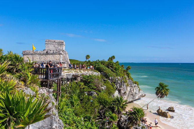 Viator Exclusive: Tulum Ruins, Reef Snorkeling, Cenote and Caves - Tulum at first light, with the Caribbean behind it